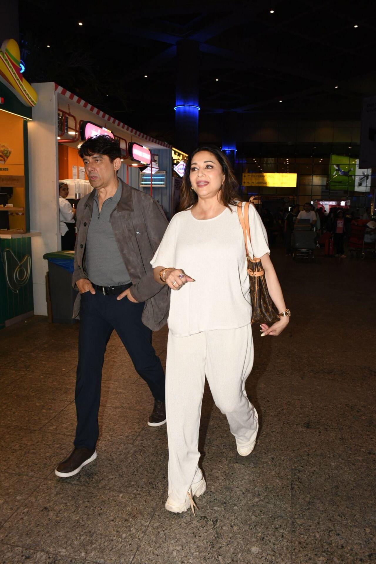 Madhuri Dixit was spotted at the airport arriving with her husband Sriram Nene. Madhuri Dixit was spotted at the airport arriving with her husband Sriram Nene.